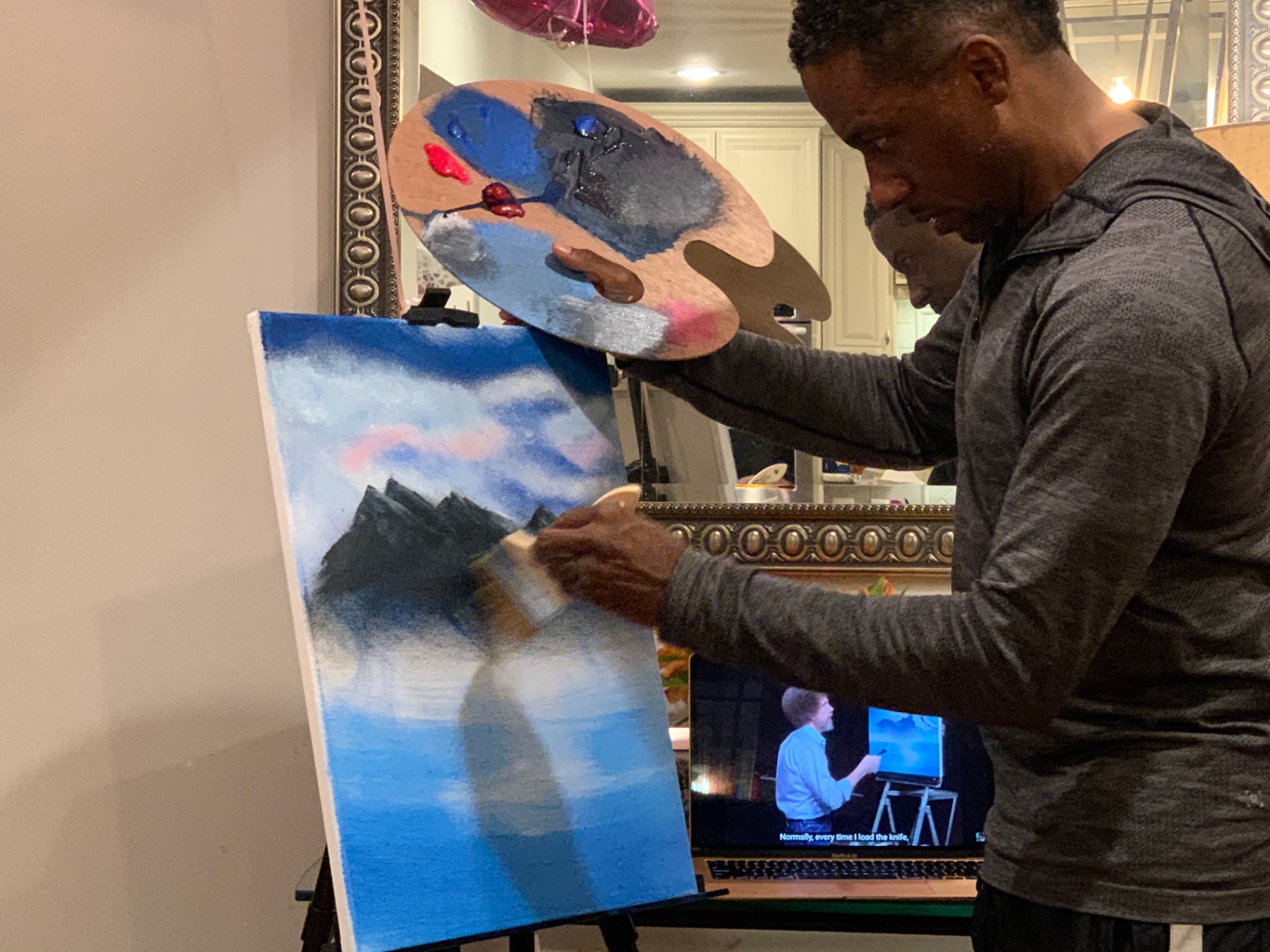 Terry Hammons painting a mountain landscape on canvas