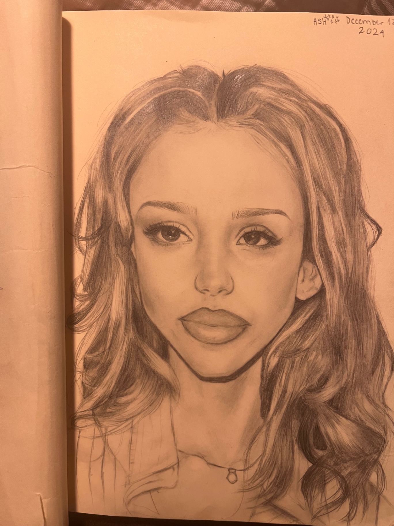 Pencil portrait of a young woman with long wavy hair and a delicate necklace