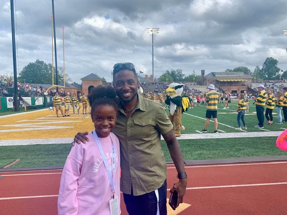 Terry and Anabelle Hammons together on the field at a football stadium