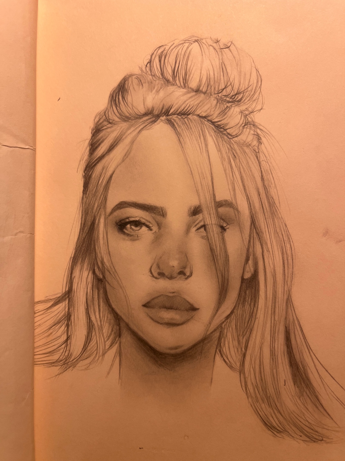 Pencil portrait of a woman with her hair pulled into a high bun and loose face-framing strands