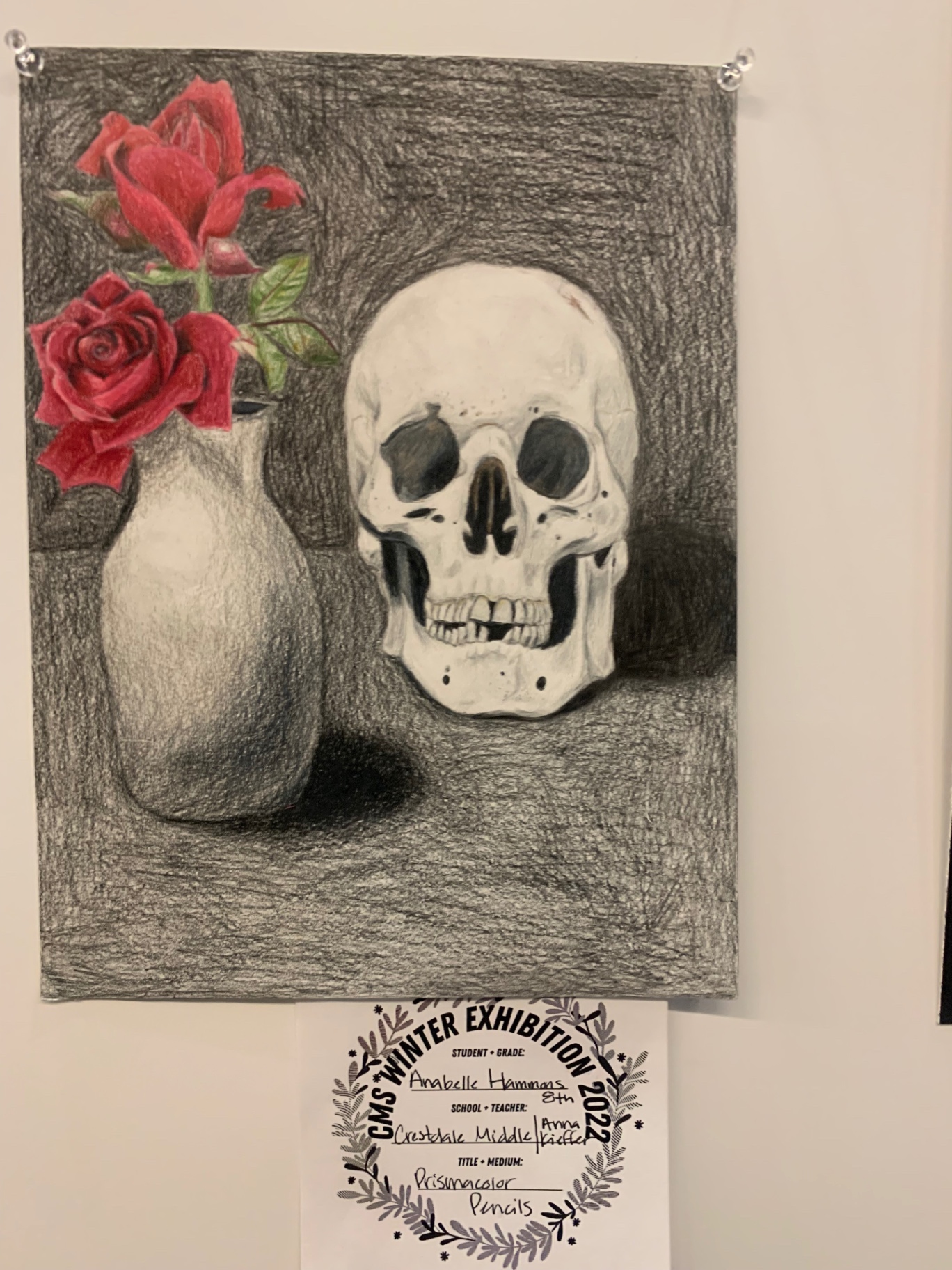 Colored-pencil still life of a white skull beside a vase of red roses
